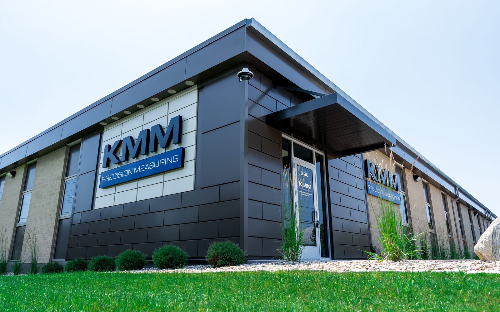 Modern black metal entrance canopy on the KMM Precision Measuring facility, fabricated and installed by Manchester Awning