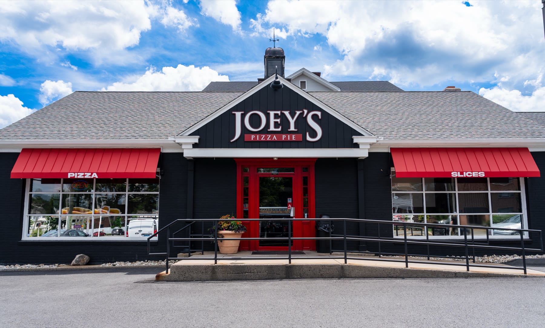Front elevation of Joey’s Pizza Pie at 353 Park Road in West Hartford, CT, with deep red standing-seam metal-look fabric awnings by Manchester Awning